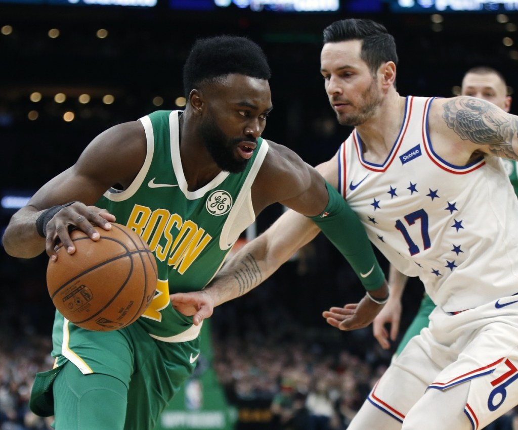 JJ Redick, right, of the 76ers tries to poke the ball away from Boston's Jaylen Brown.