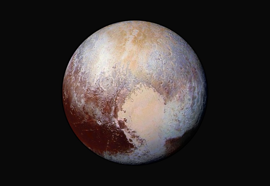 FILE - This image made available by NASA on Friday, July 24, 2015 shows a combination of images captured by the New Horizons spacecraft with enhanced colors to show differences in the composition and texture of Pluto's surface. The images were taken when the spacecraft was 280,000 miles (450,000 kilometers) away. (NASA/JHUAPL/SwRI via AP)