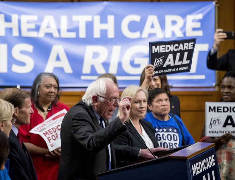 Sen. Bernie Sanders, I-Vt., center, accompanied by Sen. Kirsten Gillibrand, D-N.Y., center right, explain a Medicare for All bill that they supported in 2017.