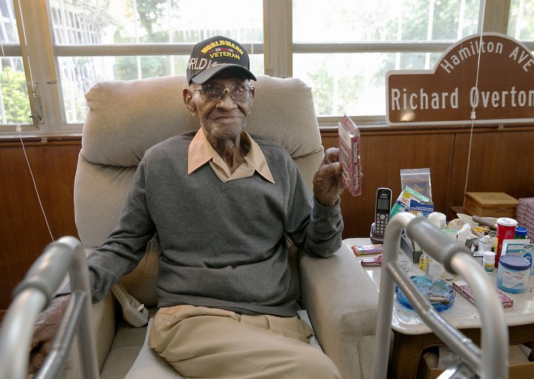 Richard Overton, then the oldest living U.S. veteran at the age of 111, sits in the home he had owned since 1948 after a renovation provided by Meals on Wheels of Central Texas and the Home Depot Foundation.