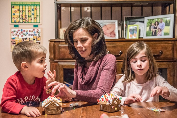 Amy Richard makes gingerbread houses with her children, Owen and Olivia, in their home in Hebron shortly before Christmas. Nearly a year after she was diagnosed with lung cancer, Richard said she is "hanging in there."