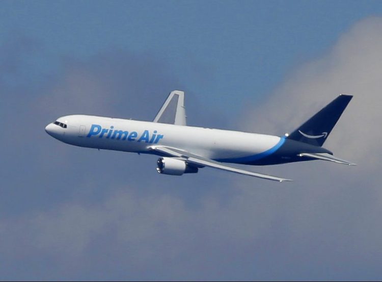 A Boeing 767 with an Amazon.com "Prime Air" livery flies over Lake Washington on August 5, 2016.   The online retailer says it will lease 10 Boeing 767s planes, which will bring its total aircraft fleet up to 50.