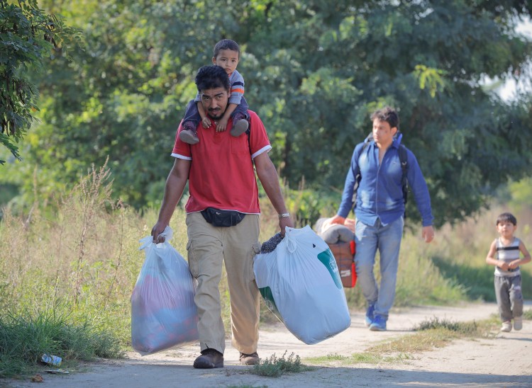 Migrants walk to a makeshift camp in Horgos, Serbia in September, 2016. 