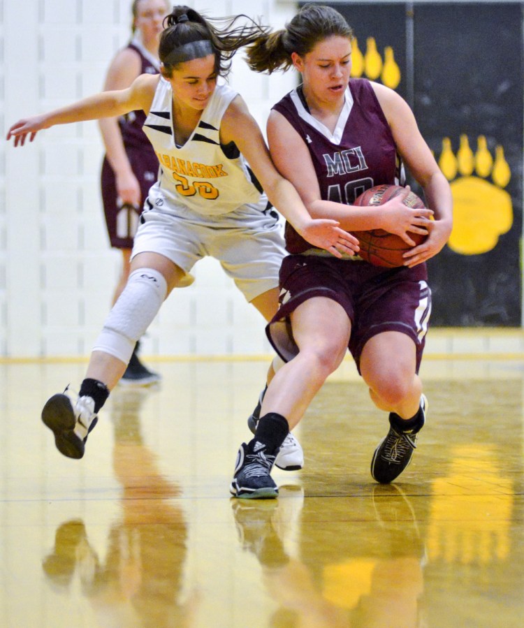 Maranacook's Kaylee Jones, left, and MCI's Sydney Farrar battle for a loose ball during a game Wednesday in the Burbank Memorial Gym in Readfield.