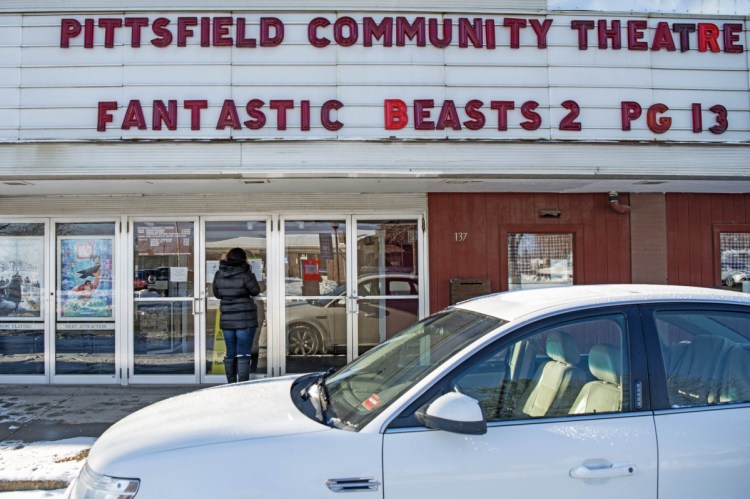 Theresa Butler looks at showtimes Thursday at the Pittsfield Community Theater on Main Street in Pittsfield. Butler said the theater is the "only thing they have going in town that parents bring their children to."