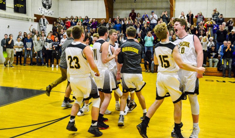 Kennebec Journal photo by Joe Phelan 
 Maranacook celebrates its 72-60 victory over Cony in a game Friday in Readfield.