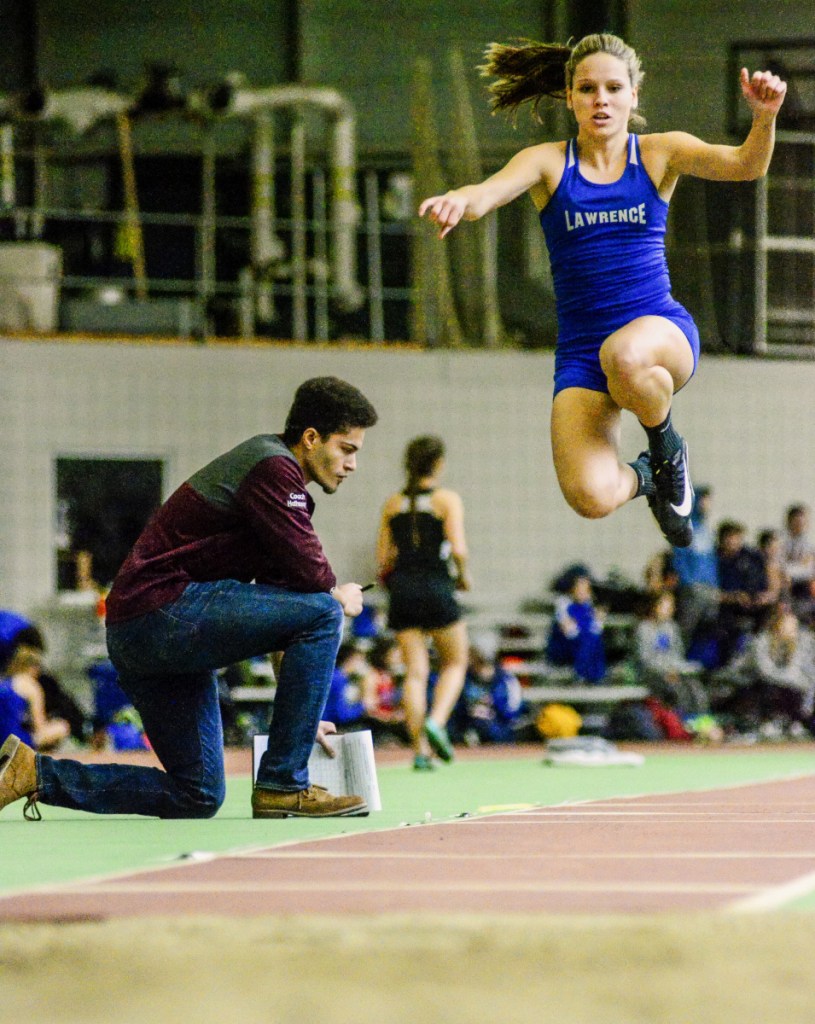 Kennebec Journal photo by Joe Phelan 
 Lawrence's Payton Goodwin flies during the triple jump Saturday at Bowdoin College in Brunswick.