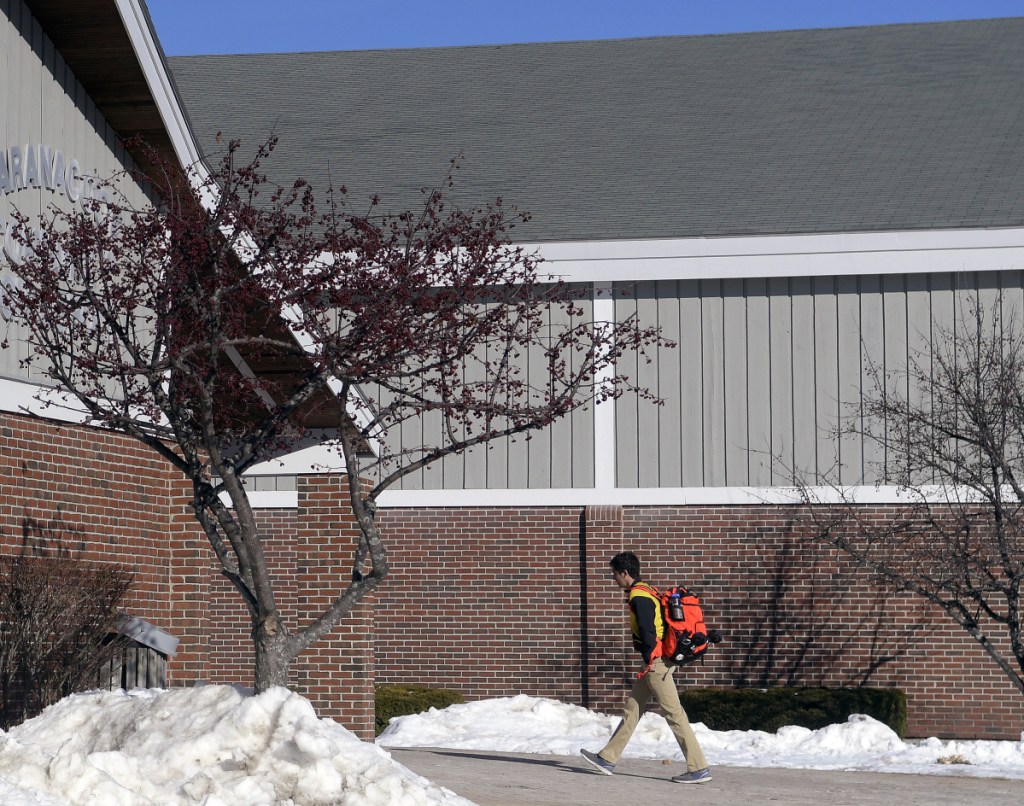 A student enters Maranacook Community High School on Monday in Readfield. The RSU 38 school board is recommending a bond to put a new roof on the school, among several facility projects.