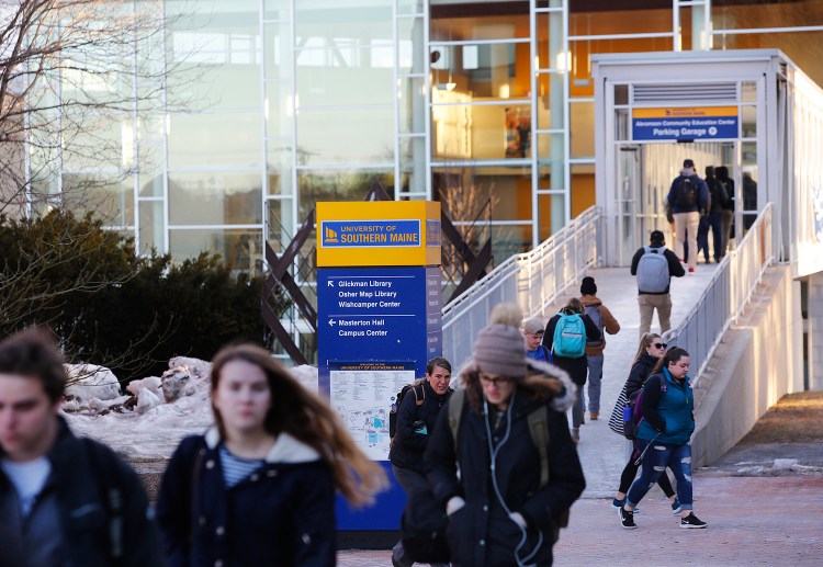 Students walk between buildings Monday on the University of Southern Maine's Portland campus. Trustees have approved a master plan that calls for new dorms, a new student center and a new campus quad in Portland.