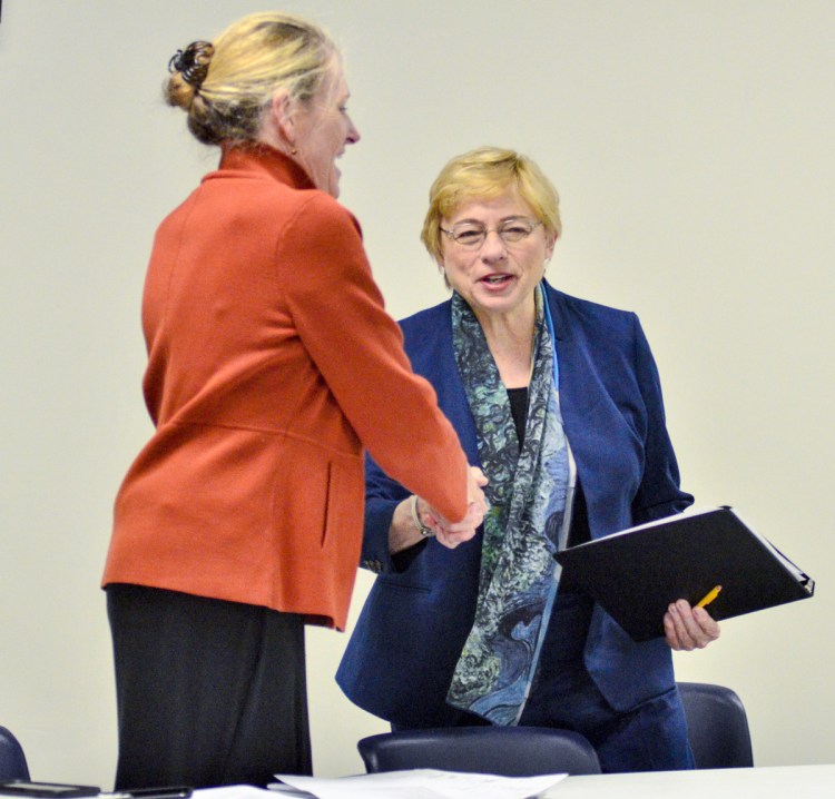 Jeanne Lambrew, the nominee to head the Department of Health and Human Service, left, and Gov. Janet Mills shake hands after Mills spoke at a session of the Medicaid Expansion Stakeholder Roundtable on Thursday at the Ice Vault in Hallowell.