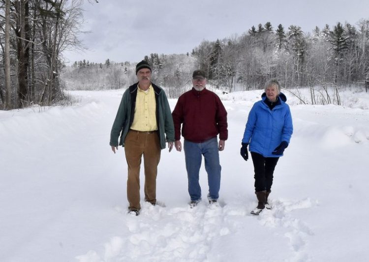 Morning Sentinel photo by David Leaming
Members of the Somerset Woods Trustees, from left, Ernie Hilton, Jack Gibson and Nancy Williams, on Thursday walk on the Weston Homestead Farm property along the Kennebec River in Madison that the trust is acquiring and will make available to the public for recreation.