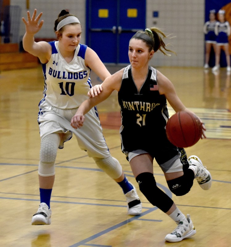 Winthrop's Katie Perkins drives against Madison's Brooke McKenney on Monday in Madison.