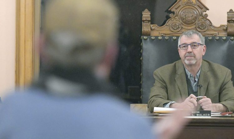 Mayor Mark Walker and City Solicitor Amy Tchao listen Monday during a Hallowell City Council meeting to a resident of Hallowell speak in favor of granting Derek Wilson, the owner of the Cannabis Healing Center at 184 Water St, a medical marijuana storefront license.