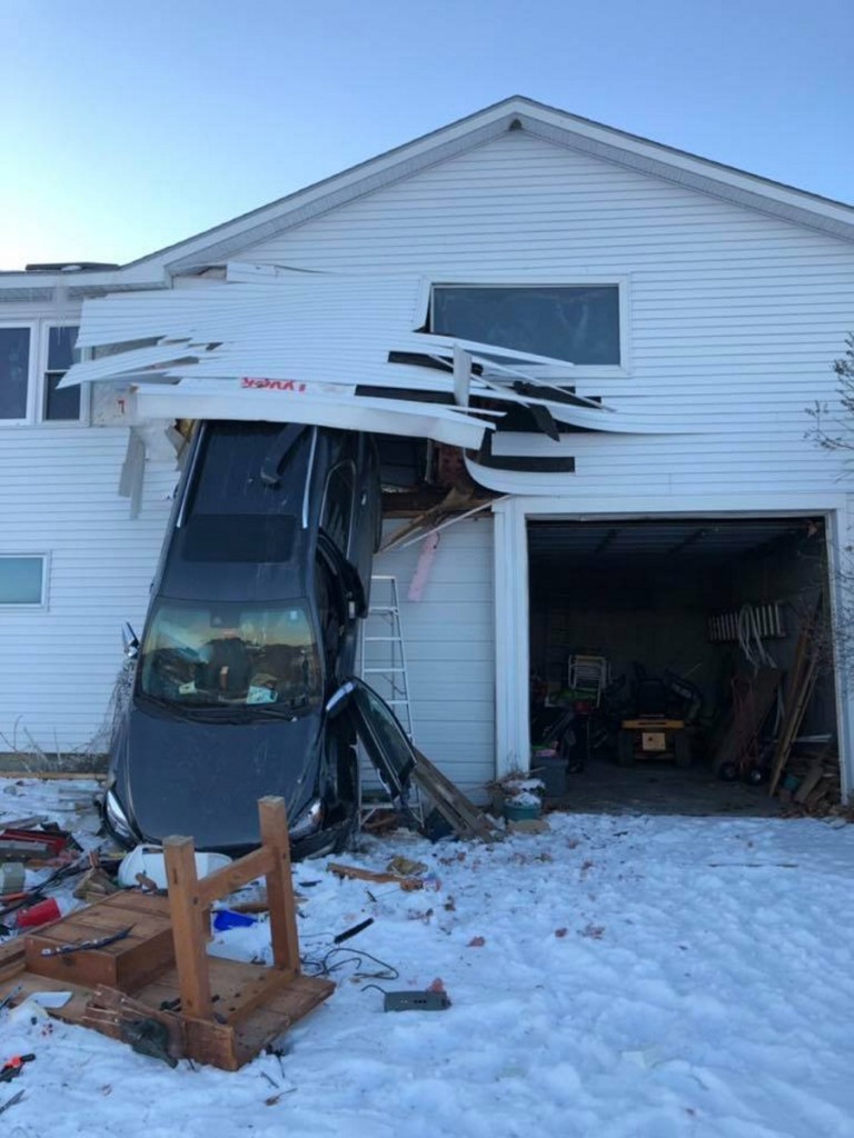 This SUV burst through the back wall of a garage Monday afternoon at a home at 100 Town Farm Road in Hallowell.