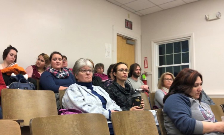 Parents who use the services of the Children's Place in Watervile listen to Executive Director Richard Dorian describe the possibility of an enrollment cutback next summer as a result of a funding shortage.