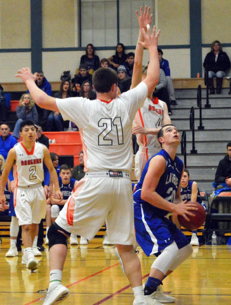 Lawrence's Gavin Herrin, right, looks to the basket as Brunswick's Sam Sharpe (21) defends during a game Tuesday night at Brunswick. The host Dragons rolled to a 60-42 victory over the Bulldogs, who fell to 5-5.