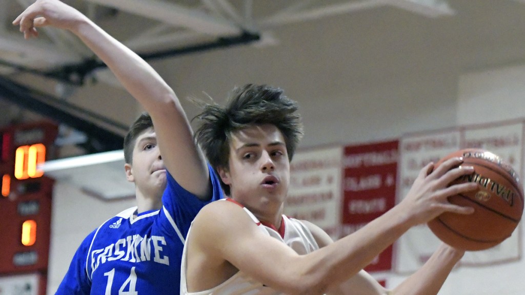 Cony's Ian Bowers, right, grabs a rebound in front of Erskine's Jacob Mortimer during a Kennebec Valley Athletic Conference Class A game Tuesday in Augusta.