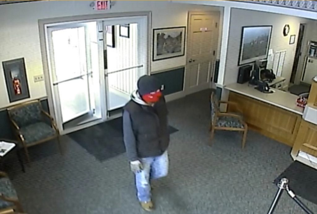 A robber enters the Skowhegan Savings Bank branch in Norridgewock in January 2018.
