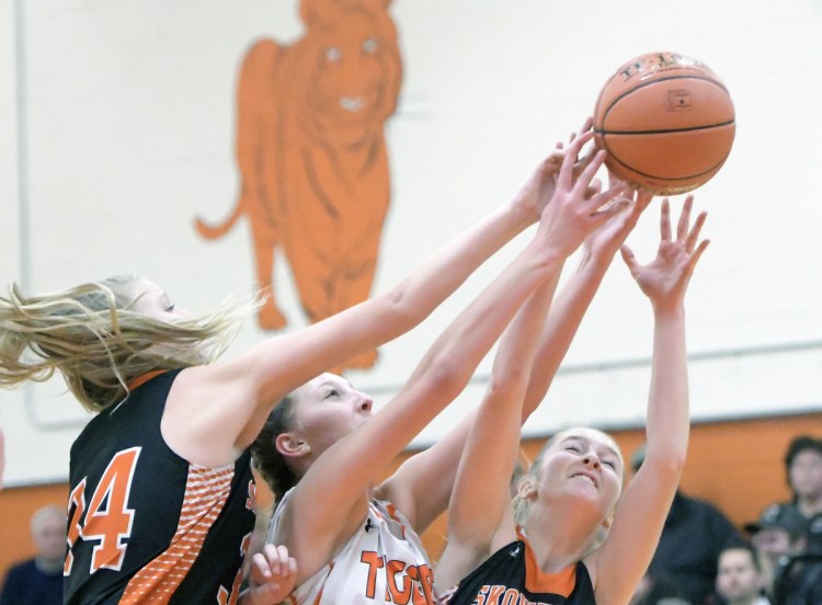 Gardiner's Bailey Poore, center, attempts to grab a rebound from Skowhegan's Sydney Reed, right, and Mariah Dunbar during a game Thursday in Gardiner.