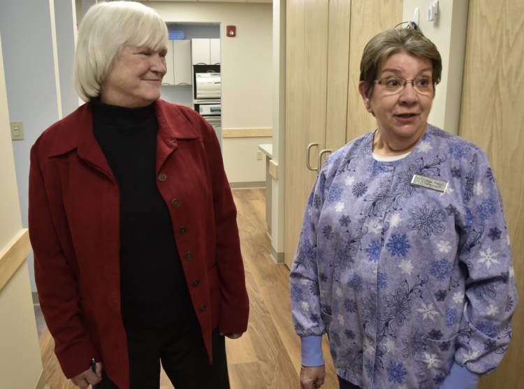 Dr. Barbara Covey, left, chairman of the board of the Waterville Community Dental Center, listens on Wednesday as dental hygienist Hope Ricker points out the benefits of the new facility located in FirstPark in Oakland, including the larger space and more accessible parking.