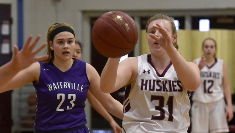 MCI senior Christa Carr takes a pass as Waterville defender Madeleine Martin closes in during a Kennebec Valley Athletic Conference Class B game Monday afternoon in Pittsfield.