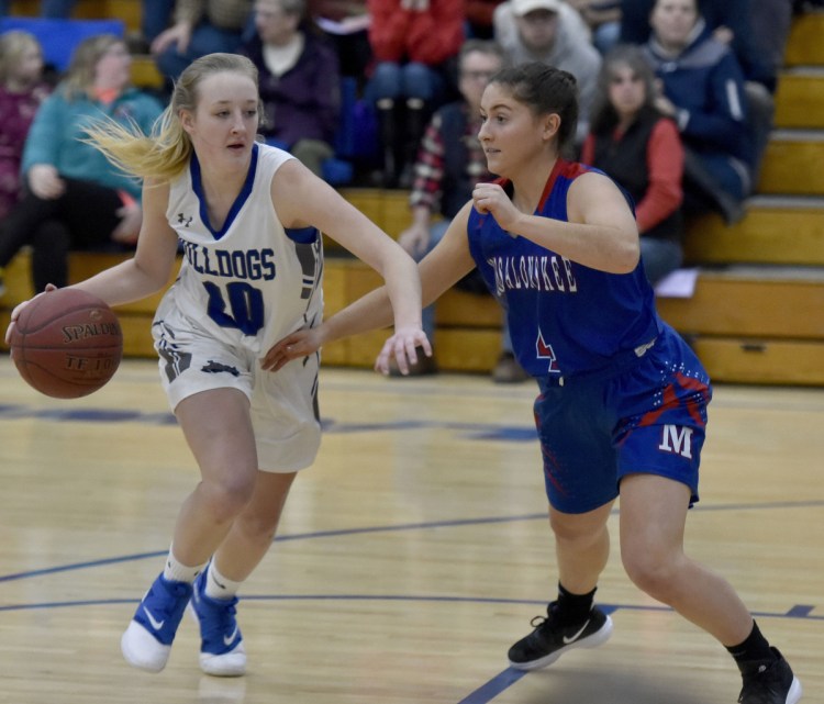 Lawrence's Keagan Alley looks to fend off Messalonskee defender Sarah Lowell during a Kennebec Valley Athletic Conference Class A North game Monday night in Fairfield.