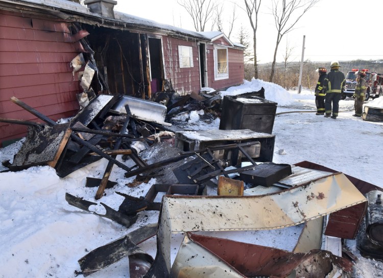 Household items were pulled from the remains of a mobile home Tuesday at 773 East Ridge Road in Cornville that was destroyed by fire. Firefighters from Cornville, Madison and Skowhegan arrived to put the fire out.