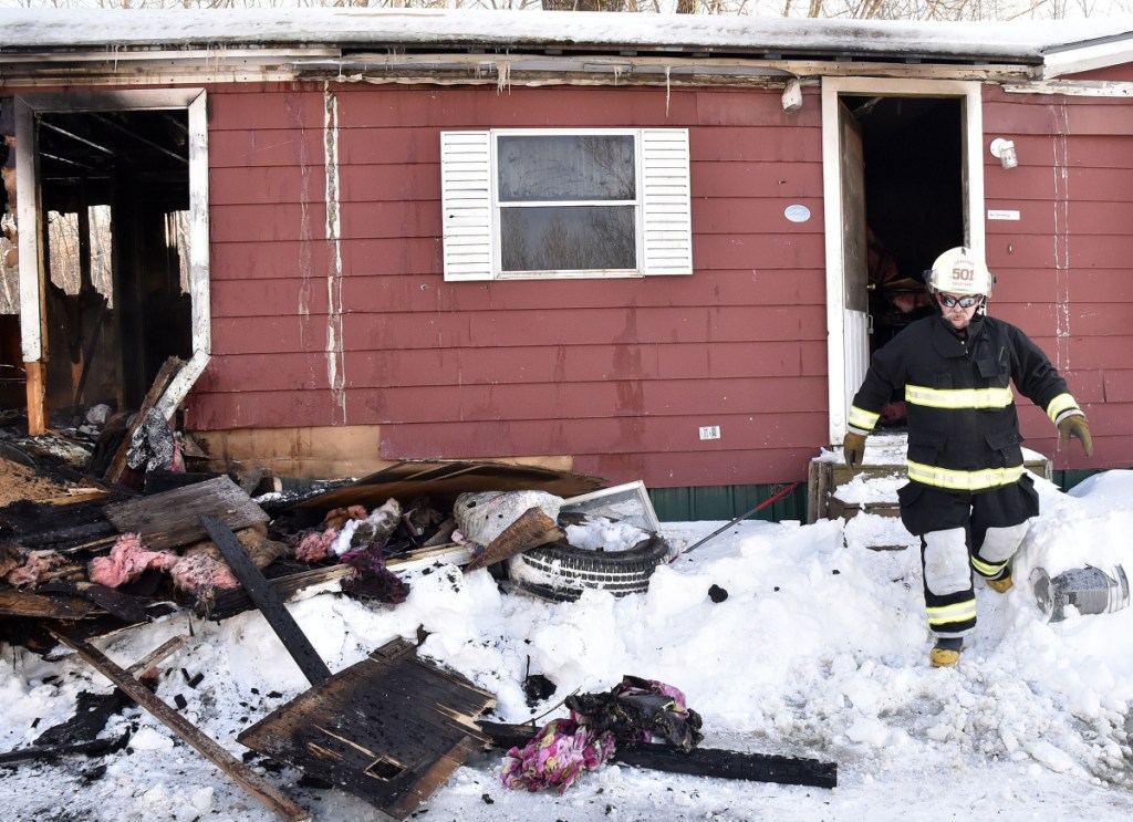 Cornville Deputy Chief Alan Nickerson exits the mobile home at 773 East Ridge Road in Cornville, which was destroyed by fire Tuesday. Nickerson said the homeowners are not insured and the fire was the result of thawing out frozen water pipes. Firefighters from Cornville, Madison and Skowhegan arrived to put the fire out.
