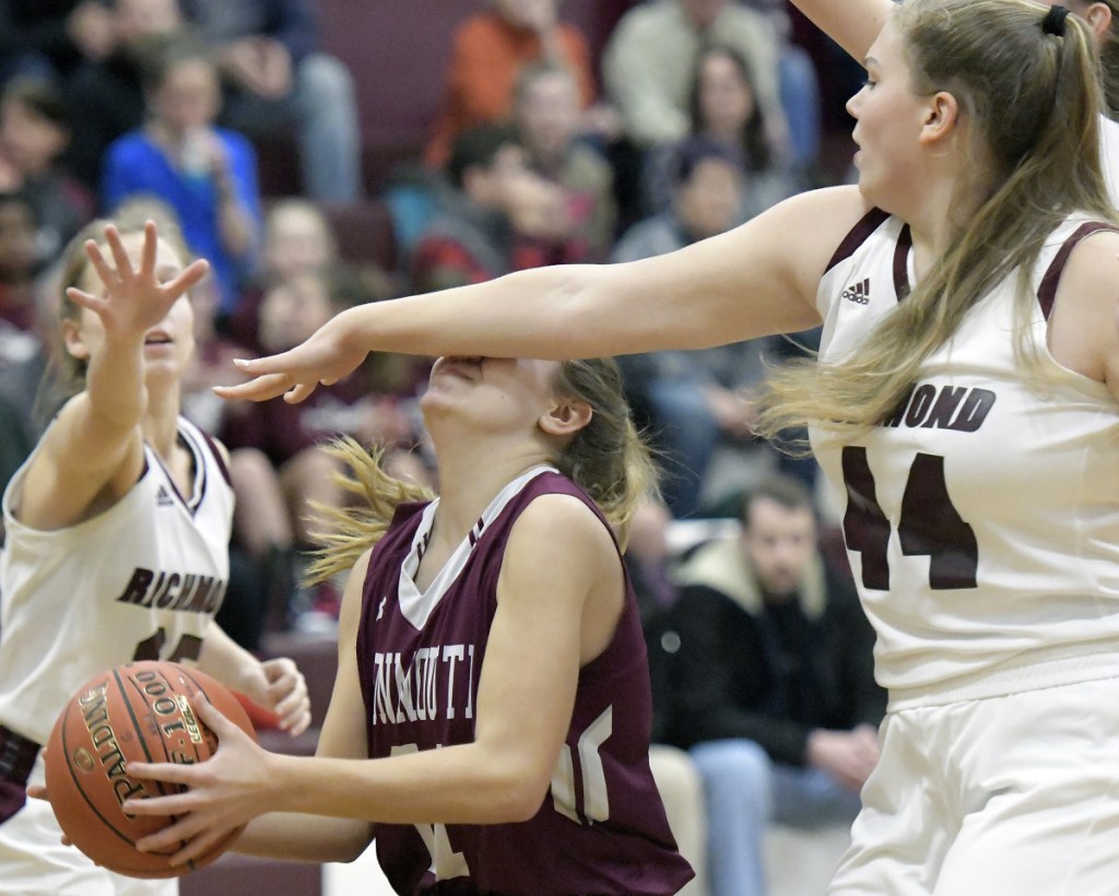 Richmond's Macy Carver (44) defends Monmouth's Abby Ferland during a Mountain Valley Conference game Thursday in Richmond.