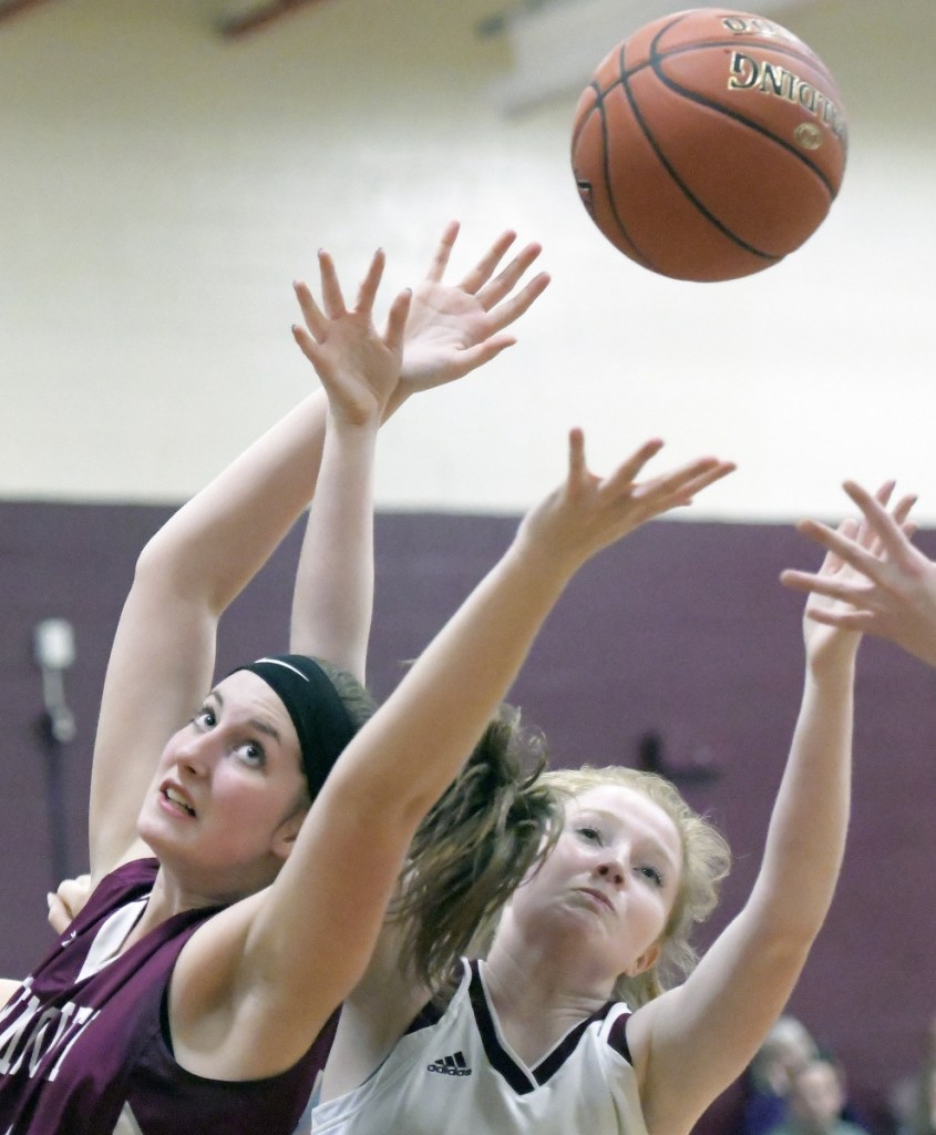 Richmond's Bryanne Lancaster, right, and Monmouth's Kaeti Butterfield reach for a rebound during a Mountain Valley Conference game Thursday in Richmond.
