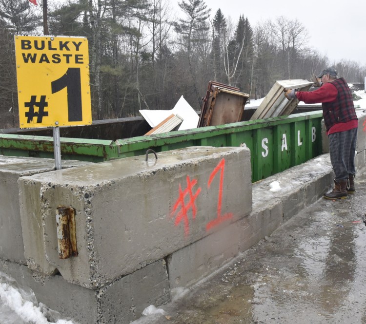 Vassalboro resident Ray Manocchio puts debris into a bulk waste dumpster Thursday at the Vassalboro Transfer Station. Vassalboro selectmen voted to end single-sort recycling at their Thursday meeting. All of the town's waste, including the recycling, goes to the Norridgewock landfill until the Fiberight plant in Hampden opens.