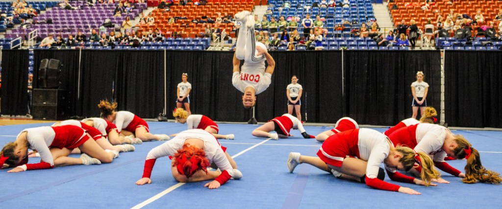 Kennebec Journal photo by Joe Phelan 
 Cony's Ethan Overlook does a flip at the end of the Rams' performance during the Class A North regional cheering competition Saturday at the Augusta Civic Center.