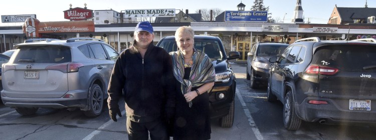 The Villager restaurant owner Joe Marcoux and Yardgoods Center owner Joyce Vlodek Atkins stand in front of their businesses in The Concourse in Waterville  on Monday. According to them, the parking lot is often filled with Colby College student vehicles, and customers have to park farther away. The City Council will consider raising parking fines and accepting a $10,000 gift from the college for parking enforcement in the two-hour lot.