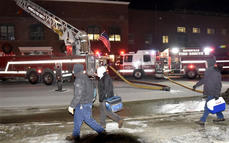 Employees at the Huhtamaki mill in Waterville and Fairfield were evacuated as fire departments from several towns responded to a fire and concentrated on the roof on Tuesday evening. Hot spots flared up Wednesday, prompting area fire departments to revisit the site of Tuesday's fire.