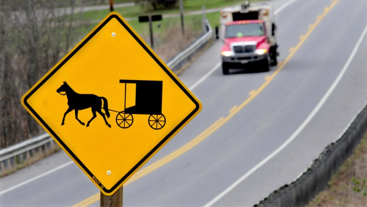 People driving into Unity see signs warning of horse-drawn wagons and buggies near a growing population of Amish.