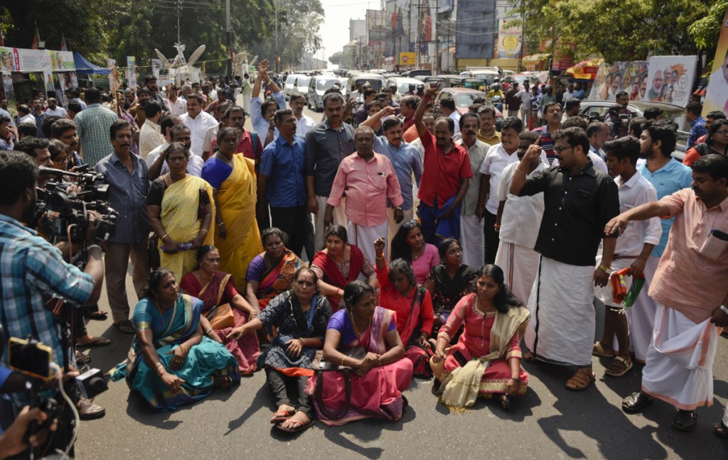 Protesters block traffic and shout slogans reacting to reports of two women of menstruating age entering the Sabarimala temple, one of the world's largest Hindu pilgrimage sites, in Thiruvananthapuram, Kerala, India, on Wednesday. The historic temple had barred women of menstruating age from entering the temple. India's Supreme Court on September 28th lifted the ban, holding that equality is supreme irrespective of age and gender. (AP Photo/R S Iyer)