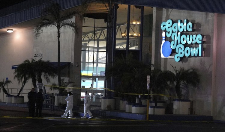 Police officers investigate a shooting at the Gable House Bowl in Torrance, Calif., on Saturday.  Police responded shortly after midnight to calls of shots fired at the bowling ally. Three people were killed and four were injured.