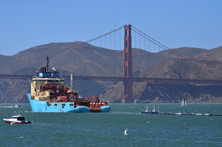 A ship tows Boyan Slat's first buoyant trash-collecting device toward the Golden Gate Bridge in San Francisco en route to a patch of 1.8 trillion pieces of plastic floating in the Pacific Ocean. After it arrived, the boom initially didn't pick up much material because it was moving slower than the plastic, allowing the trash to float away. Then the boom broke apart under constant wind and waves and is now being returned to shore for repairs.