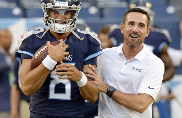 Tennessee quarterback Marcus Mariota talks with offensive coordinator Matt LaFleur before a preseason NFL football game against the Minnesota Vikings in Nashville, Tenn. A person familiar with the decision says LaFleur has accepted Green Bay's offer to become the next head coach of the Packers.
