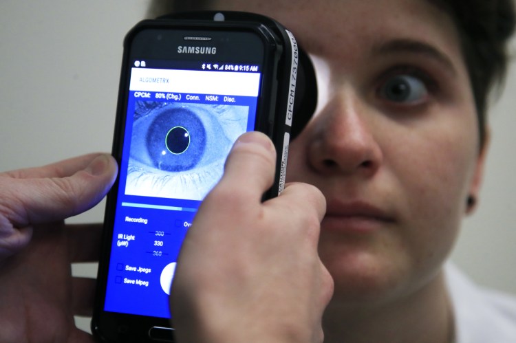 Clinical Research Assistant Kevin Jackson uses AlgometRx Platform Technology on Sarah Taylor's eyes to measure her degree of pain at the Children's National Medical Center in Washington.