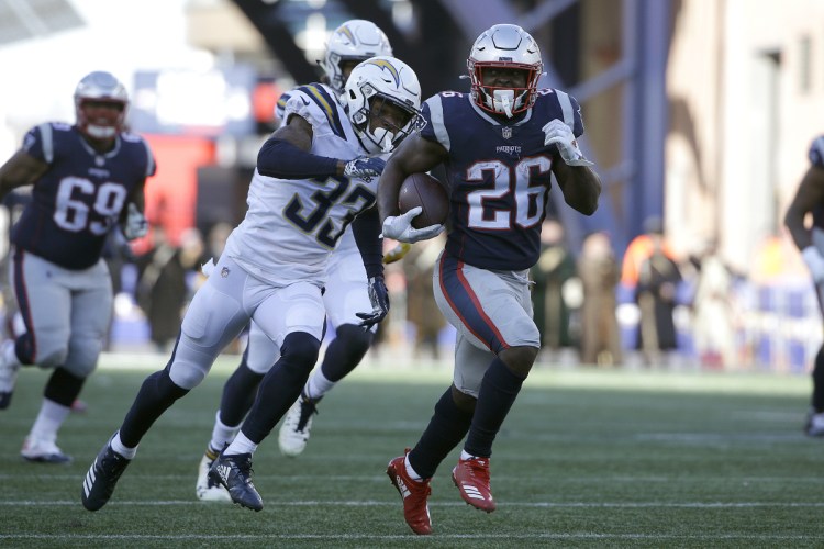 New England running back Sony Michel runs away from Los Angeles Chargers free safety Derwin James (33) during the first half of the Patriots' 41-28 win in the AFC divisional round on Sunday in Foxborough, Massachusetts. Michel rushed for 129 yards and three touchdowns to help the Patriots reach their eighth straight AFC championship game.