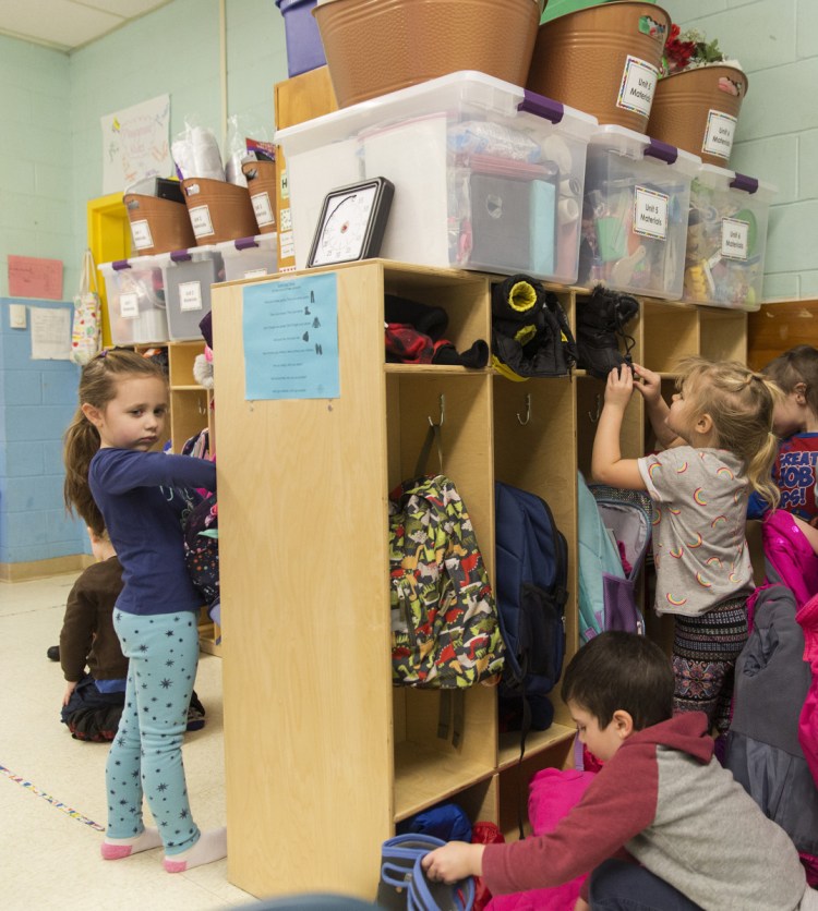 Pre-kindergarten students store their snow clothes in their cubbies after returning to class at John F. Kennedy Memorial School in Biddeford, which has one of the few districts in Maine that offer pre-K to all 4-year-olds who want to attend.