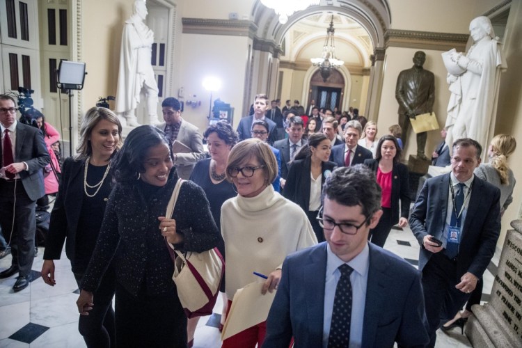 Freshmen members of the House, lead by Rep. Susie Lee, D-Nev., center, deliver a letter calling for an end to the government shutdown to the office of Senate Majority Leader Mitch McConnell of Kentucky on Capitol Hill in Washington on Wednesday. Also pictured are Rep. Katie Hill, D-Calif, left, Rep. Jahana Hayes, D-Conn., second from left, Rep. Alexandria Ocasio-Cortez, D-N.Y., center right, Rep. Angie Craig, D-Minn., second from right, and others.
