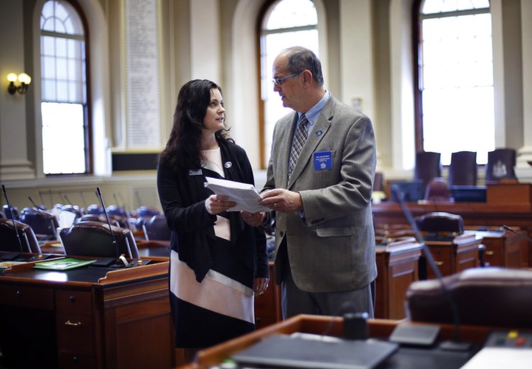  Republican state Reps. Amy Arata and her father Richard Bradstreet discuss legislation in the House Chamber at the State House in Augusta, Maine on Thursday.