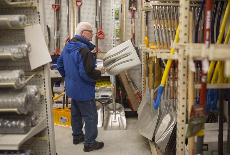 Bruce Little of Portland looks through Maine Hardware's selection of shovels Friday. The greatest uncertainty with this weekend's storm appears to be along the coast, where snow could turn to sleet at some point to keep snowfall totals down.