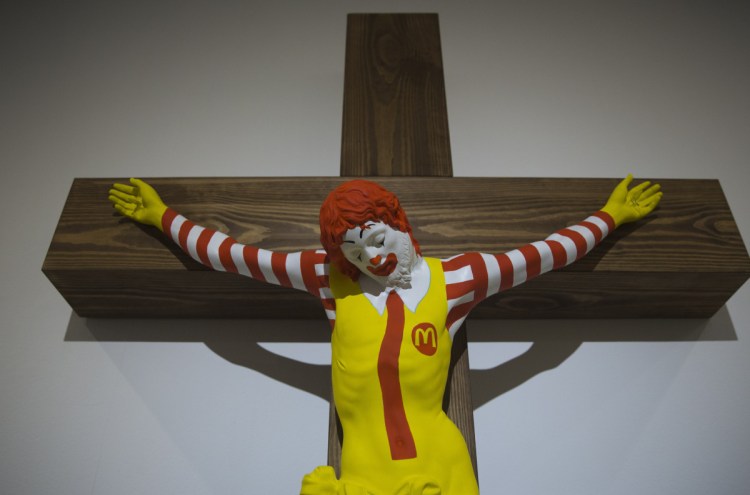 An artwork called "McJesus," which was sculpted by Finnish artist Jani Leinonen and depicts a crucified Ronald McDonald, is on display as part of the Haifa museum's "Sacred Goods" exhibit.