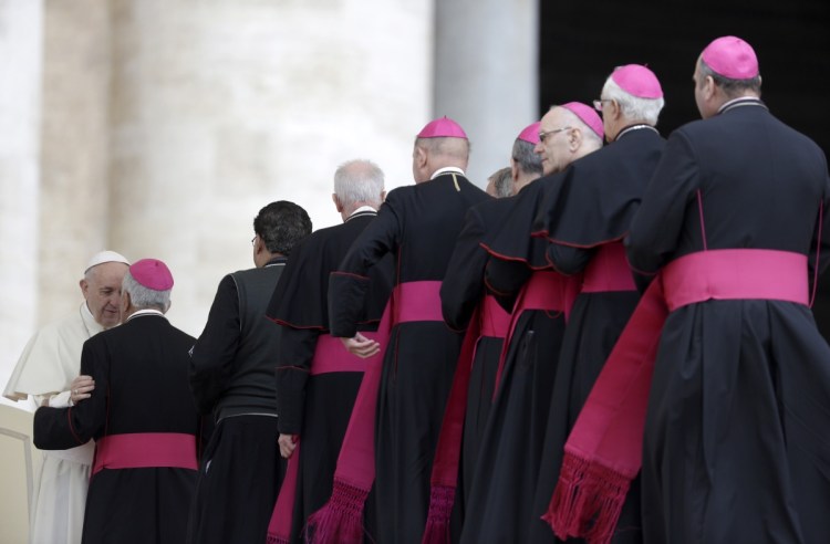 Bishops line up to greet Pope Francis during his weekly audience in St. Peter's Basilica at the Vatican last spring. Catholic doctrine mandates an all-male priesthood, on the grounds that Jesus' apostles were men.