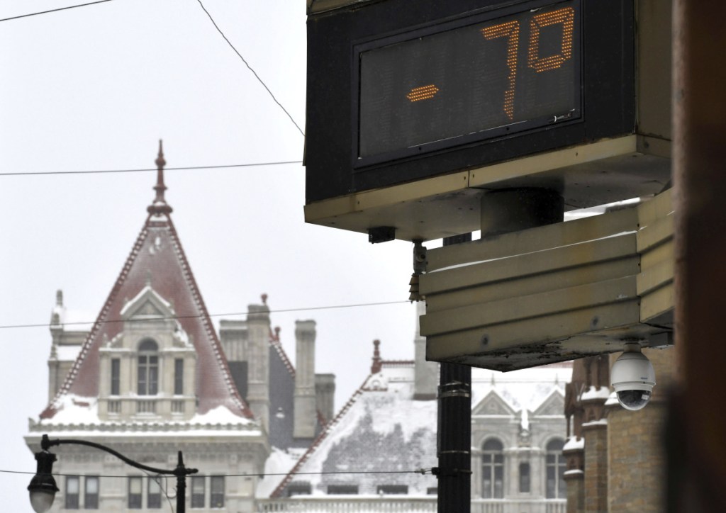 With temperatures 7 below zero in Albany, New York, and winds gusting to 3o mph windchills approached minus 40 degrees in northern New York and Vermont on Monday.
The temperature is shown at the Bank of America Financial Center on State Street against a backdrop of the New York State Capitol on Monday in Albany. Maybe more