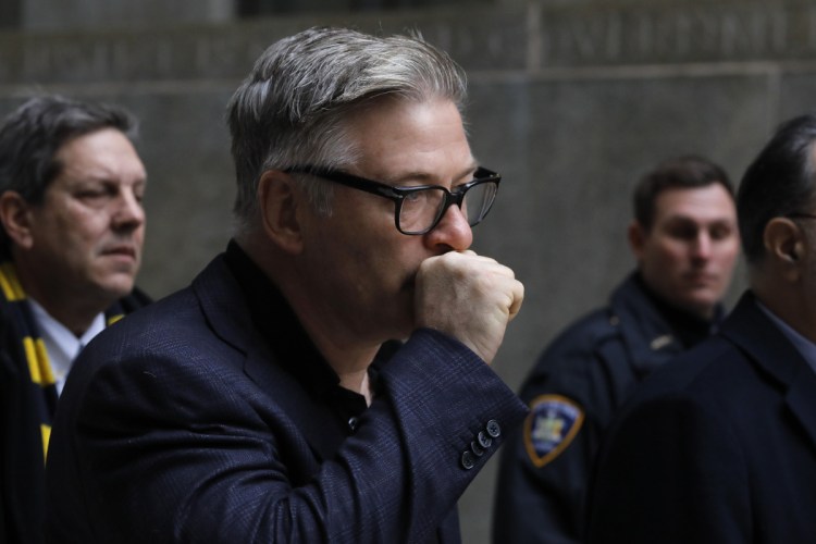 Alec Baldwin leaves court in New York City on Wednesday after a hearing on charges that he slugged a man during a dispute over a parking spot in November. 