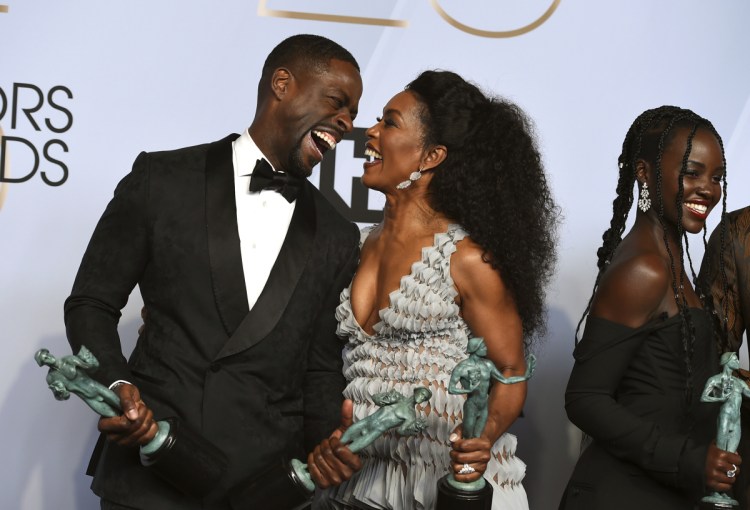 Sterling K. Brown, left, winner of the awards for outstanding performance by a cast in a motion picture for "Black Panther" and the award for outstanding performance by an ensemble in a drama series for "This Is Us," laughs with Angela Bassett, winner of the award for outstanding performance by a cast in a motion picture for "Black Panther," at the 25th annual Screen Actors Guild Awards at the Shrine Auditorium & Expo Hall on Sunday in Los Angeles.
